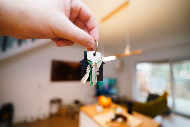 person holding up house keys