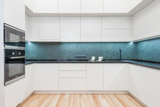 kitchen with white cabinets and a blue backsplash
