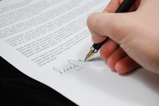 someone signing a contract