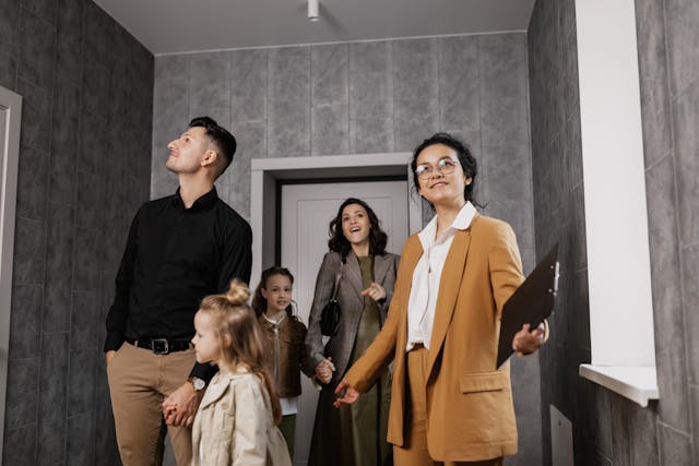Five people in the entryway of a house looking around
