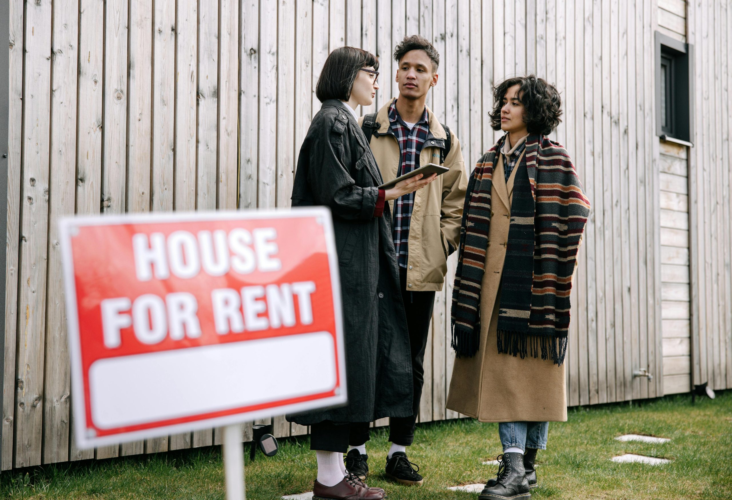 three people talking about the house for rent