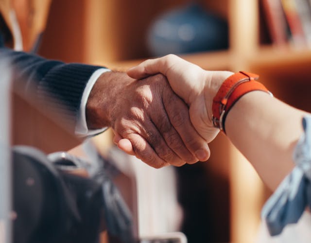two-people-shaking-hands-meeting