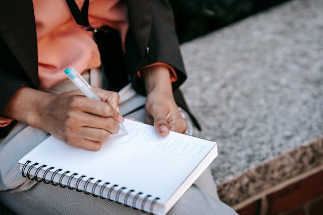 person-writing-in-notebook